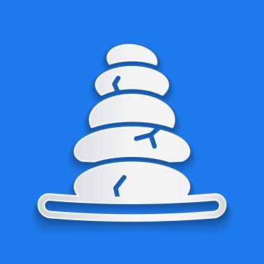 Kağıt kesiği Yığın sıcak taş simgesi mavi arkaplanda izole edildi. Spa salonu aksesuarı. Kağıt sanatı tarzı. Vektör