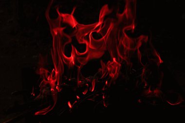 flames in the dark, a bright fire on a dark background clipart