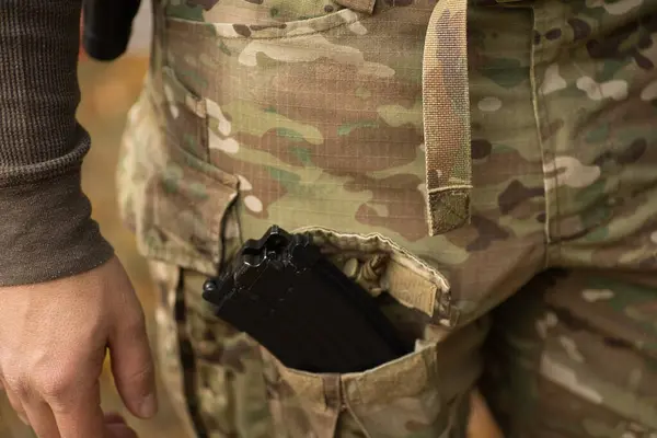 magazine from airsoft ak, in multicam pants pocket