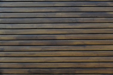 Kahverengi ahşap yapısı doğal ağaçtan geliyor. Tahta panelin güzel koyu bir deseni var, ahşap döşeme dokusu.