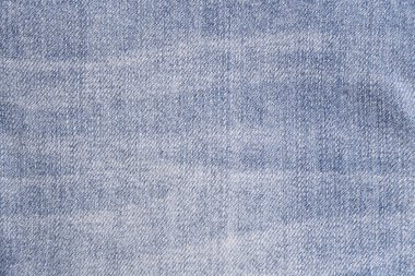 Denim kot kumaşı. Tasarım için Denim arkaplan dokusu. Kumaş kumaş. Arka plan olarak kullanılabilen mavi kot. Herhangi bir arkaplan için mavi kot dokusu.