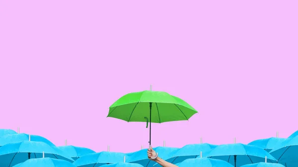 Hand Man Håller Grönt Paraply Över Blå Paraplyer Mjuk Rosa — Stockfoto