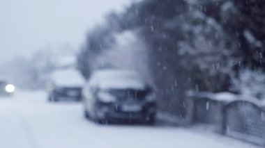 Blizzard - Heavy Snow Storm detail in SLOW MOTION HD VIDEO. Wild falling snowflakes in the wind. Slowly moving car through the street. Quarter speed.