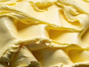 Dondurulmuş ananas aromalı dondurma - tüm çerçeve ayrıntıları. Dondurmanın sarı yüzey dokusunu kapat.