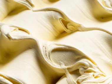 Vanilya aromalı dondurma - tüm çerçeve ayrıntıları. Vanilyalı dondurmanın bej rengi yüzey dokusunu kapat.