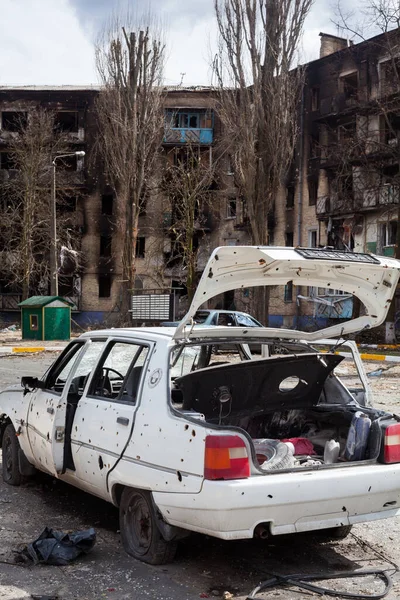 stock image Irpin, Kyiv region, Ukraine -  April 12, 2022: Russian invasion of Ukraine. Car damaged by Russian shelling. Residential district destroyed by Russian bombardments. Traces of shelling and fire. 