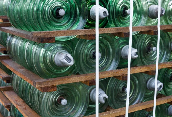 Glass disc insulator units used in suspension insulator strings for high voltage transmission lines.