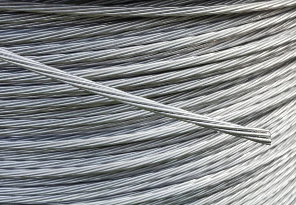 Electric galvanized steel wire on the big reel. Cable reel. Electrical wire. Close-up.