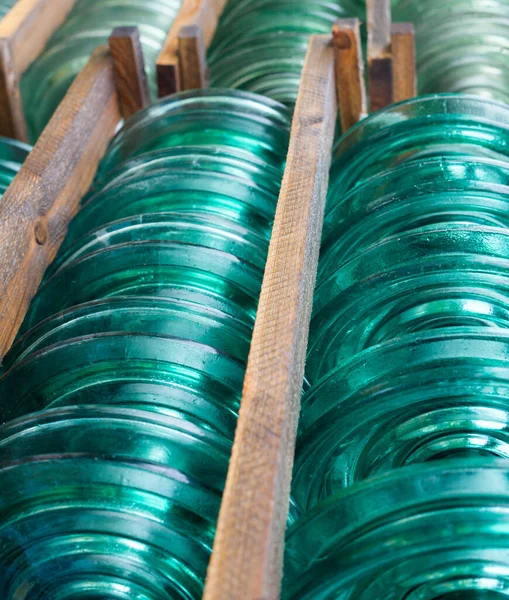 Glass disc insulator units used in suspension insulator strings for high voltage transmission lines.