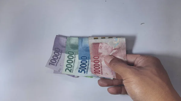Indonesian Money Hands Isolated White — Stock Photo, Image