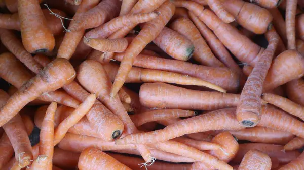 Pile of raw carrots for sale at the traditional market