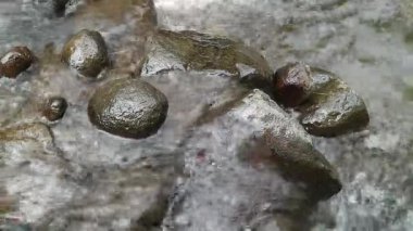 Kaybedilen su, farklı büyüklükteki taşlarla dolu bir nehirden akar. Kayalık nehir.