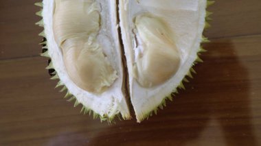 Opened durian fruit.Ripe Durian is known as King of fruits. It is smelly and the shell is covered with nails. clipart