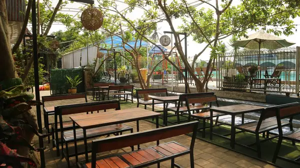 stock image outside cafe seating area with wooden chair and table