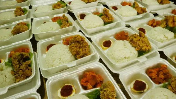 Rows of packages of rice box, crispy chicken and seasoned eggs