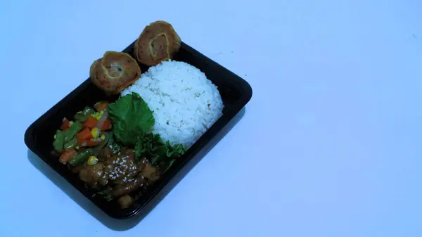 stock image Nasi Bento lunch package consist of rice, chicken rolade and vegetable, Indonesia president Prabowo government  provide free lunches for school children