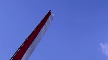 Endonezya bağımsızlık günü kutlamaları sırasında mavi gökyüzü arkaplanlı kırmızı ve beyaz flamalar, boşluğu kopyala