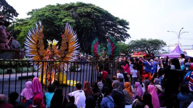 Malang, Indonesia, August 25 2024: Malang Flower Carnival is fashion parade that defines flowers as Identity of Malang City. Combining art elements, culture, tourism and history as a show-off moments for local artist. clipart