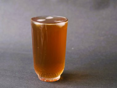 Kristal berrak bardakta zarif bir şekilde servis edilen ferahlatıcı bir bardak buzlu çay. Buzlu çayın kehribar rengi bardağın berraklığıyla güzel bir tezat oluşturuyor. Klasik bir buzlu çay, zamansız bir bardakta servis edilir, rahatlatıcı..