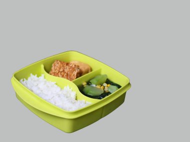 A balanced and satisfying meal of rice, fried tempeh, spinach, and squash, packed in a convenient container lunch box, ideal for students and office workers, freshly cooked, for weekdays, free lunch for student program by Indonesia president Prabowo  clipart