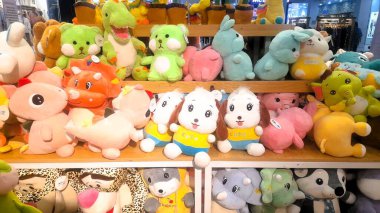 A collection of colorful and charming plush toys displayed in a shop, delights doll-loving children during their holidays. Numerous cute and vibrant dolls line the shelves, promising joy and excitement for young doll enthusiasts on vacation. clipart