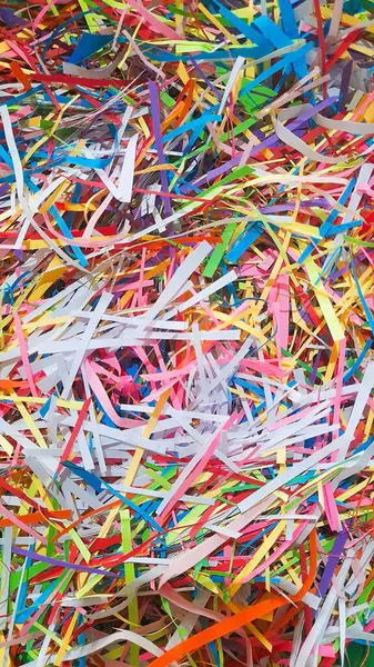 Çok renkli kağıt parçalarının soyut bir kompozisyonu sanatsal ve kutlama temalarına uygun görsel olarak canlandırıcı bir arka plan oluşturur. Renkli kağıt kırıntıları için canlı bir hava manzarası, sanat için eğlenceli bir zemin ve şenlik vesilesi..