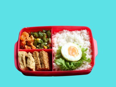 A balanced, healthy meal of rice, egg, stir-fried vegetables, and tofu-tempeh, in a lunchbox, suits busy students and office workers. A free lunch program by Prabowo in Indonesia served in a lunchbox. clipart