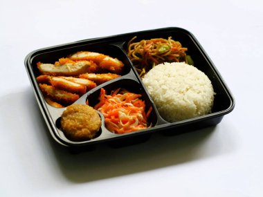 Katsu chicken, rice, noodles, mashed potatoes, vegetable salad, and fritter served on bento box meal isolated white, copy space. Suitable for students and busy worker, home business opprtunity