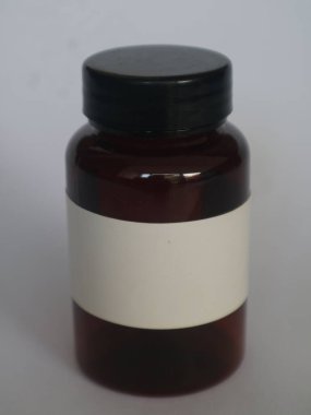 Beyaz etiketli, siyah kapaklı, izole edilmiş beyaz ilaç için kahverengi cam şişe.