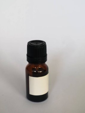 Brown glass bottle for medicine with a blank white label and a black cap, isolated white