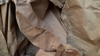 Kahverengi buruşuk kağıt yaprak dokusu, 4k video, desenli kağıt arka plan. Eskiz defteri, tasarım, retro stil, kırışıklık, yıpranma, boşluk için mükemmel