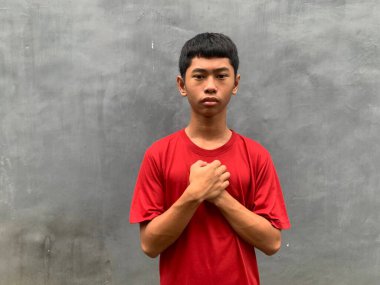 a southeast asian person looking down, conveying low self-confidence or being a victim of bullying with signs of poor mental health