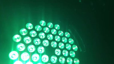 Gleaming, multi-colored lights in green, blue, red, and yellow create a sparkling background perfect for a party, celebration, or victory, 4k footage