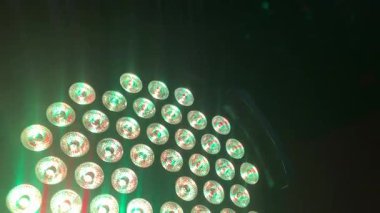 Gleaming, multi-colored lights in green, blue, red, and yellow create a sparkling background perfect for a party, celebration, or victory, 4k footage