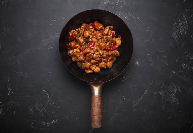 Wok lezzetli kung pao tavuğu ile doludur. Yumuşak tavuk, çıtır fıstık ve canlı sebzelerle. Hepsi lezzetli bir sosla kaplıdır.