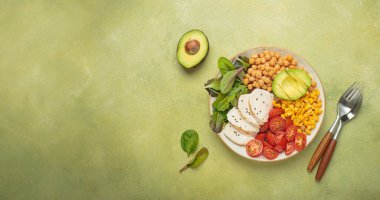 Kızarmış tavuk göğsü, nohut, avokado, mısır ve domatesli sağlıklı bir kase, dengeli ve besleyici bir yemek ve sağlıklı bir yaşam tarzı.