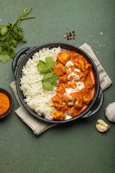 Aromatik Hint tavuğu tikka masala pilav ve kişniş, zerdeçal, sarımsak, tarçın çubukları, geleneksel Hint yemeği.