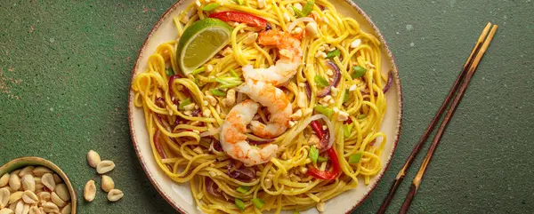 Karides, yer fıstığı, limon, kırmızı dolma biber ve yeşil soğanlı nefis Tayland eriştesi.