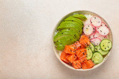 Poke bowl, geleneksel Hawai yemeği dilimlenmiş çiğ somon, avokado, pirinç ve sebzelerle servis edilen sebzeler, arka planda sağlıklı bir yemek, kopyalama alanı.