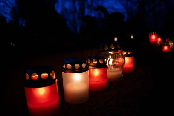 stock image Grave candles glowing in a dark