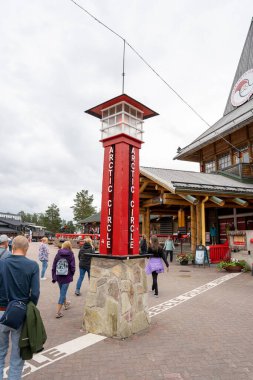 Rovaniemi, Finlandiya - 07.01.2024: Noel Baba Köyü 'ndeki Kuzey Kutup Dairesi geçidinde turistler