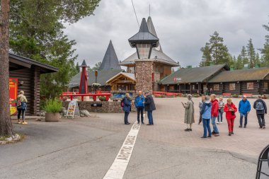 Rovaniemi, Finlandiya - 07.01.2024: Noel Baba Köyü 'ndeki Kuzey Kutup Dairesi geçidinde turistler