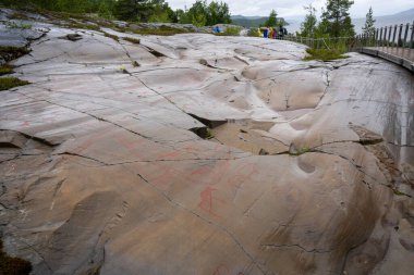 Alta, Norway - 07.03.2024: Tourists viewing the Rock Art of Alta in Norway clipart