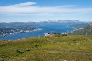 Fjellheisen cable car station on Mount Storsteinen and view over Tromso, Norway from Storsteinen viewpoint clipart