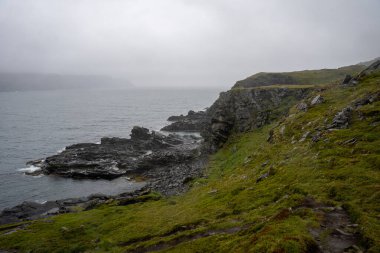 Coastal cliffs next to Kirkeporten in Skarsvag, Norway clipart