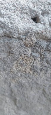 A rough cement wall showcasing tiny holes that add unique character. clipart