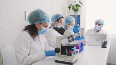 doctor woman laboratory assistant conducts a study of water samples