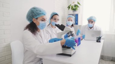 Medical Development Laboratory: portrait of a beautiful african american woman, Scientist Looking Under Microscope, People do Medicine, Biotechnology Research in Advanced Lab, work in the laboratory