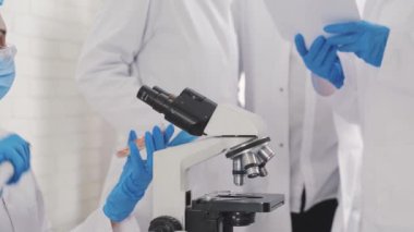 urinalysis in the laboratory, a container with a urine test, a female laboratory assistant of Asian appearance