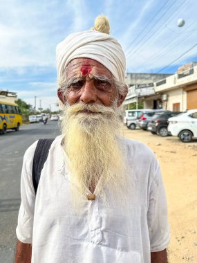 Pushkar, Rajasthan, India - November 2022: Portrait of rajasthani male with colorful turban on head during pushkar camel fair.